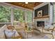 Screened in porch with wood-burning fireplace and comfortable seating arrangement at 2493 Oostanaula Ne Dr, Brookhaven, GA 30319