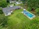 Spacious backyard features a sparkling pool, green lawn, and mature trees, perfect for outdoor enjoyment at 3190 Crestview Circle Nw Cir, Duluth, GA 30096