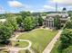 This aerial captures the historic charm of the city hall amidst the city park at 3190 Crestview Circle Nw Cir, Duluth, GA 30096