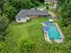 Aerial view of a home with a spacious backyard and an inviting in-ground swimming pool at 3190 Crestview Circle Nw Cir, Duluth, GA 30096
