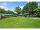 Expansive backyard features a sparkling in-ground pool and mature trees offering shade at 3190 Crestview Circle Nw Cir, Duluth, GA 30096