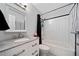 Bathroom with a white vanity and granite top, subway tile shower, and black-and-white accents at 3190 Crestview Circle Nw Cir, Duluth, GA 30096