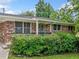 A charming brick home with a covered porch, surrounded by lush green bushes at 3190 Crestview Circle Nw Cir, Duluth, GA 30096