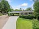 A well-maintained single-story home with a long driveway and a covered carport at 3190 Crestview Circle Nw Cir, Duluth, GA 30096