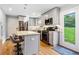 Well-lit kitchen with stainless steel appliances, island seating, and an open view to the backyard at 3190 Crestview Circle Nw Cir, Duluth, GA 30096