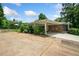 A home with a large, paved side area, greenery, and a covered carport at 3190 Crestview Circle Nw Cir, Duluth, GA 30096