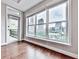 Bedroom corner with a view of the city skyline, hardwood floors, and access to a balcony at 3334 Peachtree Ne Rd # 614, Atlanta, GA 30326