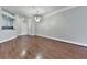 Empty dining room with wood floors, decorative light fixture, and pass-through to the kitchen at 3334 Peachtree Ne Rd # 614, Atlanta, GA 30326