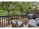 Relaxing back deck with cushioned seating, string lights, and a grill, perfect for outdoor entertaining at 5147 Manerdale Se Dr # 5, Vinings, GA 30339