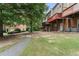 Backyard featuring a walking path and decks on the rear of brick townhomes at 5147 Manerdale Se Dr # 5, Vinings, GA 30339