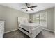Cozy bedroom with a large window, ceiling fan, and neutral colors, offering a peaceful retreat at 5147 Manerdale Se Dr # 5, Vinings, GA 30339