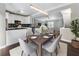 Open dining area with modern lighting, neutral color palette, and easy access to the kitchen and living room at 5147 Manerdale Se Dr # 5, Vinings, GA 30339