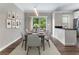 Stylish dining room with modern lighting, decor, and sliding glass doors to outdoor space at 5147 Manerdale Se Dr # 5, Vinings, GA 30339