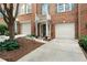 Two-story brick home with a well-manicured lawn, a two car garage and a welcoming entrance at 5147 Manerdale Se Dr # 5, Vinings, GA 30339