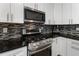 Well-equipped kitchen featuring stainless steel appliances, granite countertops, and stylish backsplash at 5147 Manerdale Se Dr # 5, Vinings, GA 30339
