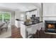 Modern kitchen with stainless steel appliances, fireplace, breakfast bar, and easy access to the back deck at 5147 Manerdale Se Dr # 5, Vinings, GA 30339