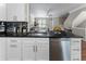 Bright kitchen with white cabinets, stainless steel appliances, granite counters, and an open view to the living room at 5147 Manerdale Se Dr # 5, Vinings, GA 30339