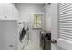 Functional laundry room featuring modern washer and dryer and ample storage space at 5147 Manerdale Se Dr # 5, Vinings, GA 30339