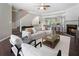 Open-concept living room with fireplace, modern furnishings, and lots of natural light at 5147 Manerdale Se Dr # 5, Vinings, GA 30339
