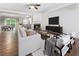Open-concept living room with fireplace, modern furnishings, and lots of natural light at 5147 Manerdale Se Dr # 5, Vinings, GA 30339