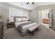 Serene main bedroom with neutral tones, a large window, and access to the en-suite bathroom at 5147 Manerdale Se Dr # 5, Vinings, GA 30339