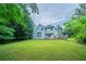 Expansive backyard with green lawn, mature trees, and a well-maintained lawn ideal for recreation at 621 Lakewater View Dr, Stone Mountain, GA 30087