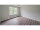 Neutral bedroom with great natural light and modern flooring with a view of the surrounding landscape at 621 Lakewater View Dr, Stone Mountain, GA 30087