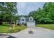 Charming two-story home features a two-car garage and a well-manicured front yard at 621 Lakewater View Dr, Stone Mountain, GA 30087