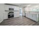 Bright kitchen features modern appliances, white cabinets, and quartz countertops at 621 Lakewater View Dr, Stone Mountain, GA 30087