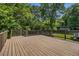 A spacious, sunny backyard deck surrounded by mature trees and lush greenery at 821 Erin Sw Ave, Atlanta, GA 30310