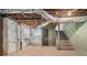 Unfinished basement with concrete floor, exposed ductwork, and concrete stairs at 821 Erin Sw Ave, Atlanta, GA 30310