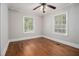 Bedroom with hardwood floors, gray walls, white trim, and two bright windows at 821 Erin Sw Ave, Atlanta, GA 30310