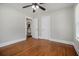 Bedroom features hardwood flooring, neutral walls, white trim, ceiling fan and a hallway view at 821 Erin Sw Ave, Atlanta, GA 30310