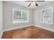 Bedroom featuring wood floors, two windows providing natural light, gray walls and white trim at 821 Erin Sw Ave, Atlanta, GA 30310