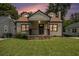 Charming home with a cozy front porch and well-manicured lawn at 821 Erin Sw Ave, Atlanta, GA 30310