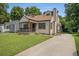 Inviting home showcasing a lush front yard, cozy porch and a long driveway at 821 Erin Sw Ave, Atlanta, GA 30310