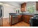 Kitchen features stainless dishwasher, black countertops and wooden cabinets at 821 Erin Sw Ave, Atlanta, GA 30310
