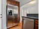 Kitchen features stainless refrigerator, dishwasher, dark countertops and wooden cabinets at 821 Erin Sw Ave, Atlanta, GA 30310