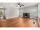 Hardwood floors and a fireplace in this naturally lit living room at 821 Erin Sw Ave, Atlanta, GA 30310