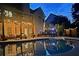 Backyard pool with outdoor seating and lighting and a lovely home in the background at 1012 Chestnut Creek Dr, Villa Rica, GA 30180
