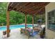 Beautiful backyard with covered patio, outdoor seating and in-ground pool at 1012 Chestnut Creek Dr, Villa Rica, GA 30180