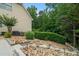 Backyard view of home features landscaping and outdoor lighting at 1012 Chestnut Creek Dr, Villa Rica, GA 30180