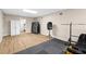 Finished basement with wood-look floors features workout area, storage, and neutral paint at 1012 Chestnut Creek Dr, Villa Rica, GA 30180