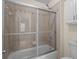 Bathroom featuring a shower with a glass door and tile surround, and white cabinets at 1012 Chestnut Creek Dr, Villa Rica, GA 30180