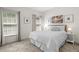 Bright bedroom featuring neutral walls, carpet floors, and natural light from two large windows at 1012 Chestnut Creek Dr, Villa Rica, GA 30180
