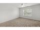 Bright bedroom with a ceiling fan, window, and plush carpet flooring at 1012 Chestnut Creek Dr, Villa Rica, GA 30180