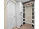 Bright walk-in closet features built-in shelving and drawers for maximum organization at 1012 Chestnut Creek Dr, Villa Rica, GA 30180