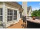 Cozy outdoor deck with table, chairs and grill, perfect for entertaining and enjoying outdoor living at 1012 Chestnut Creek Dr, Villa Rica, GA 30180