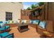 Outdoor deck space with built in seating, pillows, firepit, and a mounted television at 1012 Chestnut Creek Dr, Villa Rica, GA 30180
