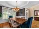 Formal dining room featuring hardwood floors, chandelier, and large windows at 1012 Chestnut Creek Dr, Villa Rica, GA 30180